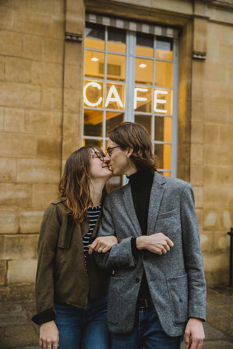 A romantic couple posing together during a photoshoot in Paris.