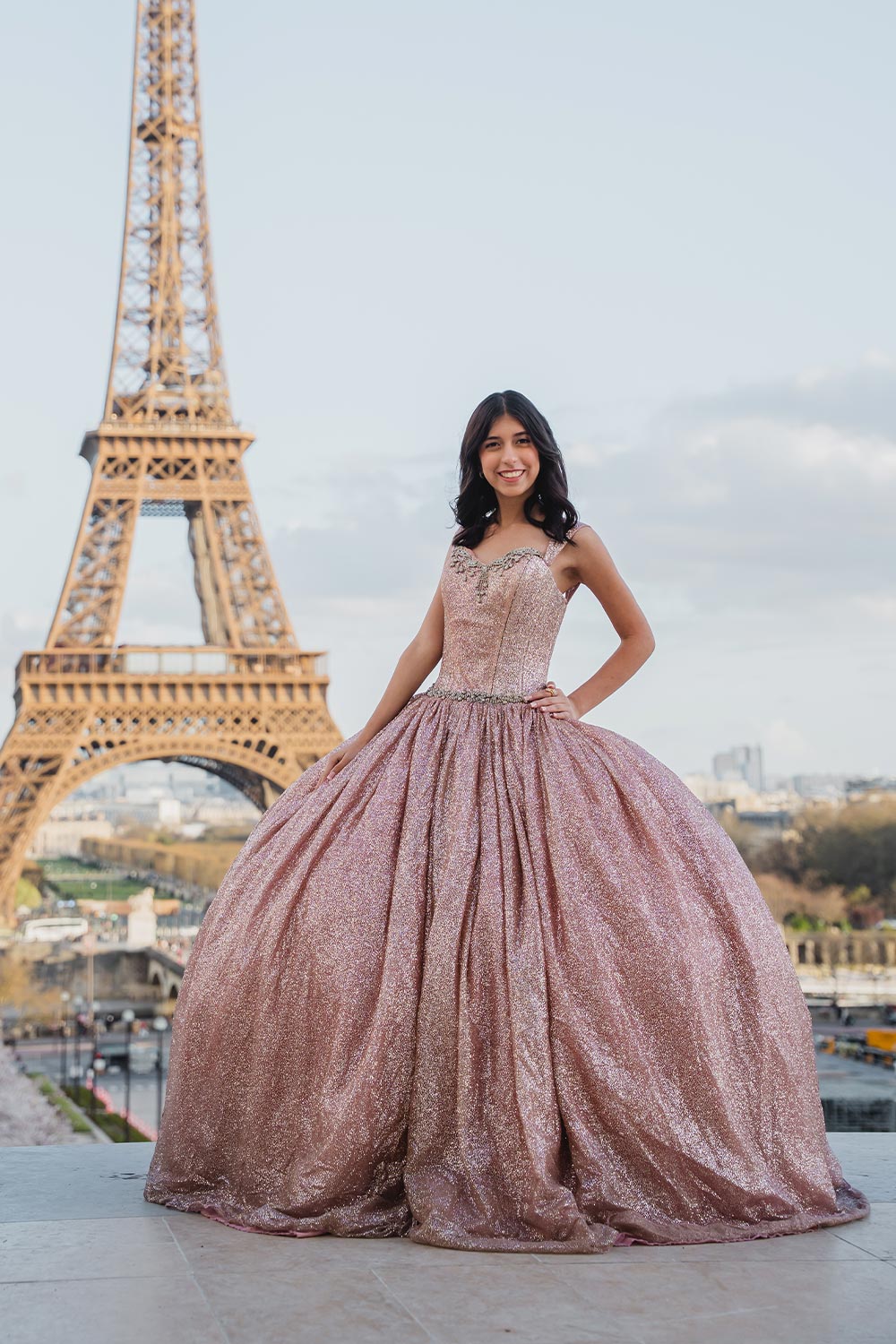Quinceañera con vestido rosa dorado brillante posando en el Trocadéro frente a la Torre Eiffel / Quinceañera in a sparkling rose gold gown posing at the Trocadéro in front of the Eiffel Tower